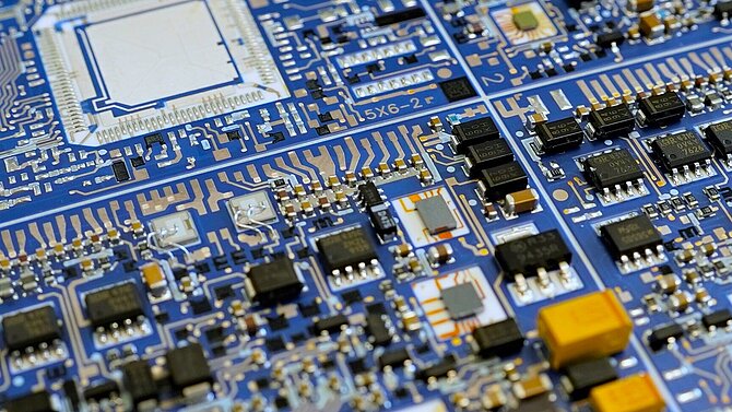 A blue printed circuit board from CeramTec with passive components.