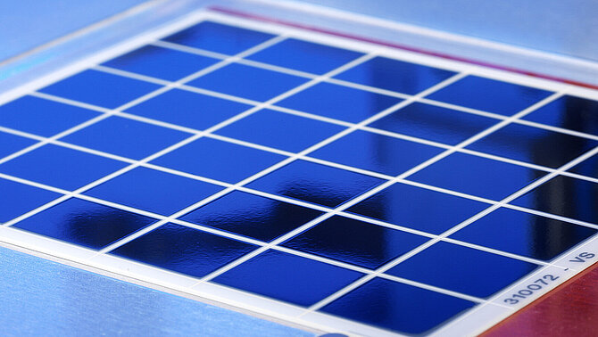 A blue metallised substrate is being machined.