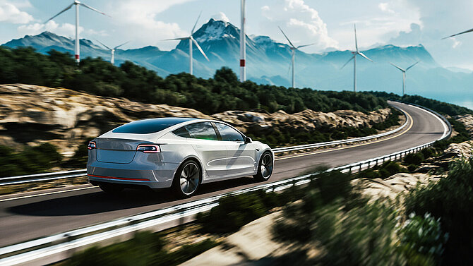 Electric car drive on the wind turbines background