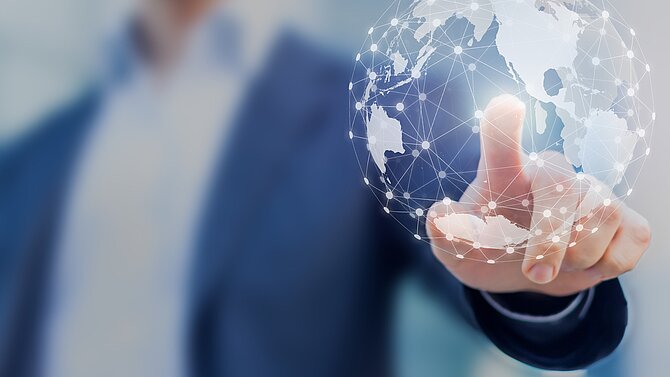 Man touching a holographic Globe