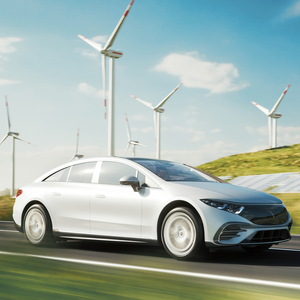 A modern electric car is driving on a country road, next to it the Substrate-One-Stop-Shop logo from CeramTec.